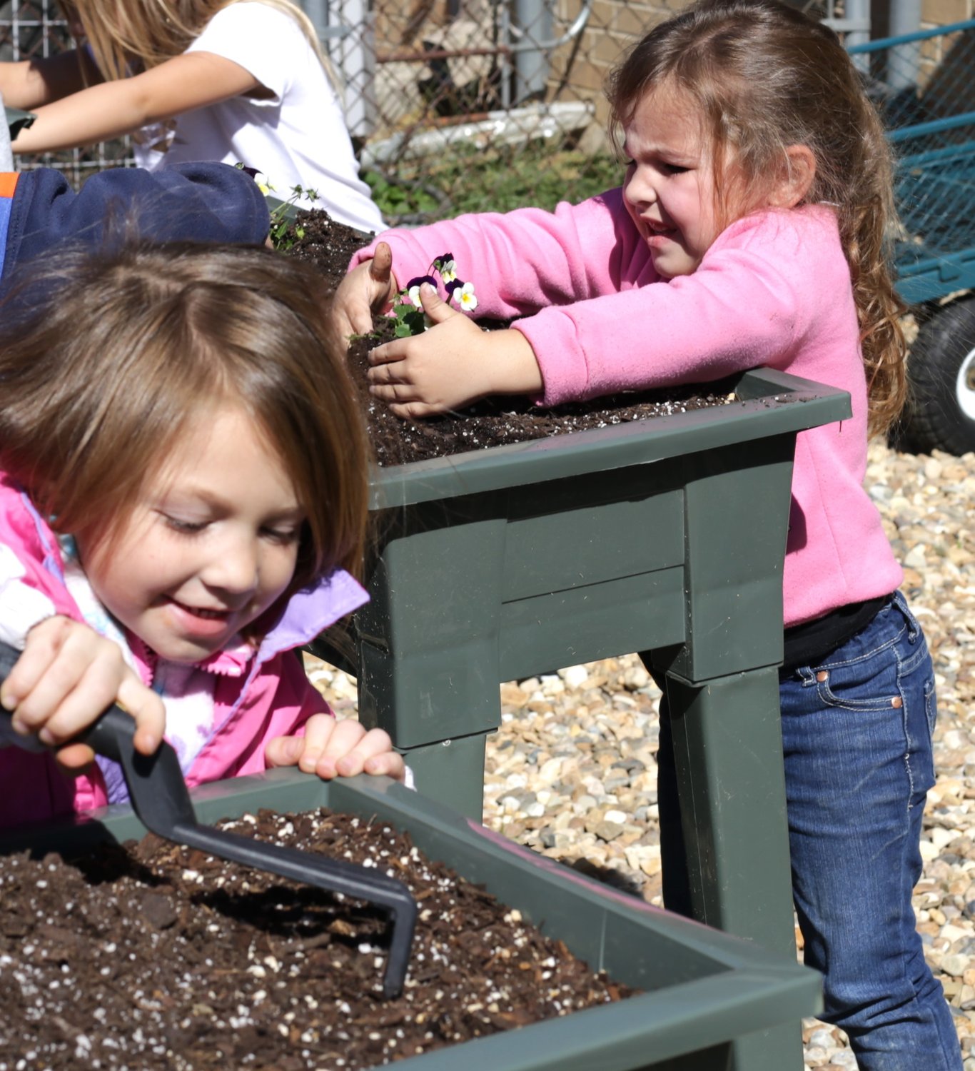 Cara Kelley and Haven Tingley, both of Mrs. Landry’s kindergarten class, enjoy the new garden.